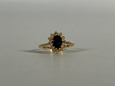 a close up of a gold ring with a blue stone