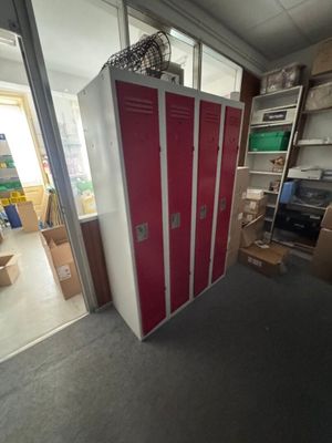 a red and white locker in the middle of a room
