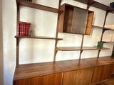a book shelf with books on it in the corner of a room