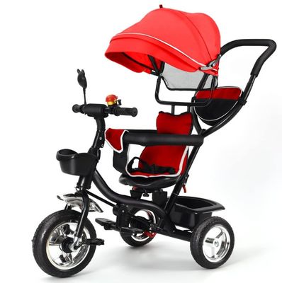a small child ' s tricycle with a red canopy