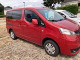 a red van that is parked on the side of the road