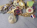 a pile of medals and medals sitting on a table