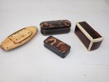 four pieces of wood are sitting on a table next to each other