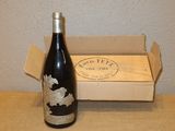 une bouteille de vin posée sur une table à côté d'une boîte