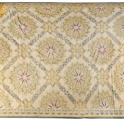 an antique rug with a floral design on a white background