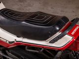 a red and white motorcycle parked in a garage