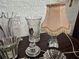 a table that has a lamp, vases, and a lamp shade on it