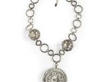 a silver necklace with a medallion pendant on a chain