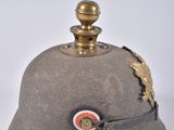an old helmet with a gold star on it sitting on a white surface