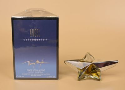 angel celebration eap spray bottle next to a box of perfume