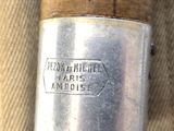 a close up of a metal object with a wooden handle