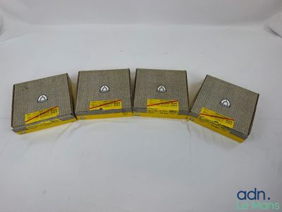 quatre boîtes de savon posées sur une surface blanche