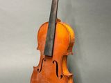 an old violin sitting on top of a gray surface
