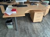 a wooden desk with a computer on top of it