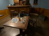 a wooden table with a book on it in the middle of a room