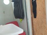 a bathroom with a sink and a trash bag hanging on the wall