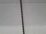 a close up of a chain hanging from the side of a wall