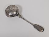 a silver spoon with a spoon handle on a white surface