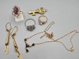 a lot of jewelry that is laying out on the table