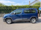 a blue van that is parked in a parking lot
