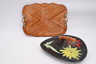 brown leather purse and plate with flowers on it on a white surface