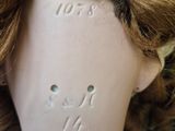 a close up of a doll ' s head with hair on it