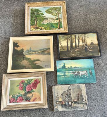 many paintings on the floor of this room