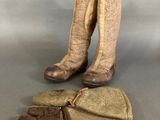 two pairs of boots and mitts are sitting on a table