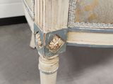a close up of a bed with a floral design on the headboard