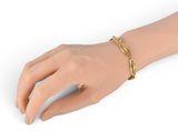 a close up of a person ' s hand wearing a gold bracelet