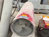 a red blower sitting on the ground next to other blowers