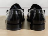 a pair of black shoes that are on a table