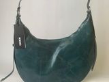 the purse is green and has a black tag on it