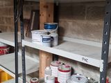 many shelves with paint and other items on them