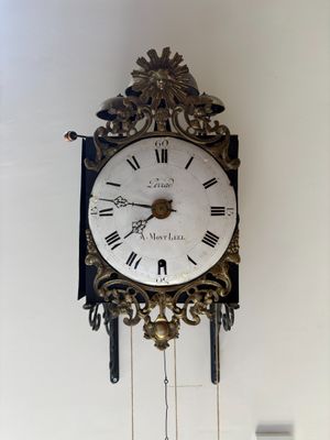 a clock that is hanging on the wall in the room