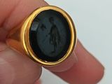 a person holding a ring with a picture of a man on it
