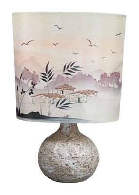 a lamp that is sitting on a table with a lamp shade on it