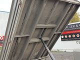 a dumpster that is sitting on the side of the road