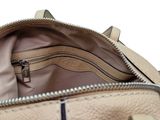 the inside of a beige purse with a zipper on it