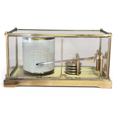 a glass display case with a barometer inside of it
