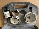 three holes in a tool case with a bottle of water