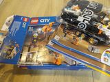 two lego city sets sitting on a table next to each other