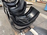 a lot of black plastic chairs sitting on a pallet