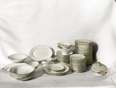 a lot of white plates and bowls on a table