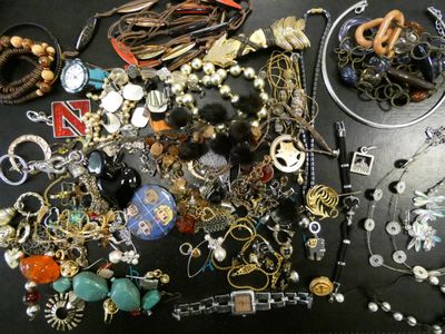 many different types of jewelry on a black table