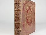 an old book with gold and red designs on it