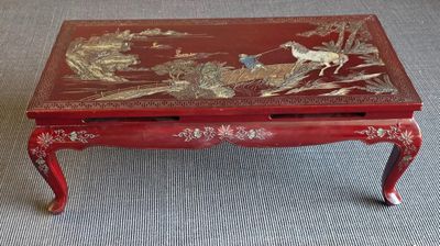 a red coffee table with a bird design on it