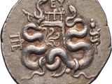 a close up of a silver coin with a snake on it
