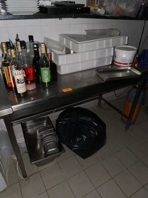 a table with a lot of bottles on it in a kitchen