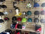 many helmets hanging on the wall in this garage